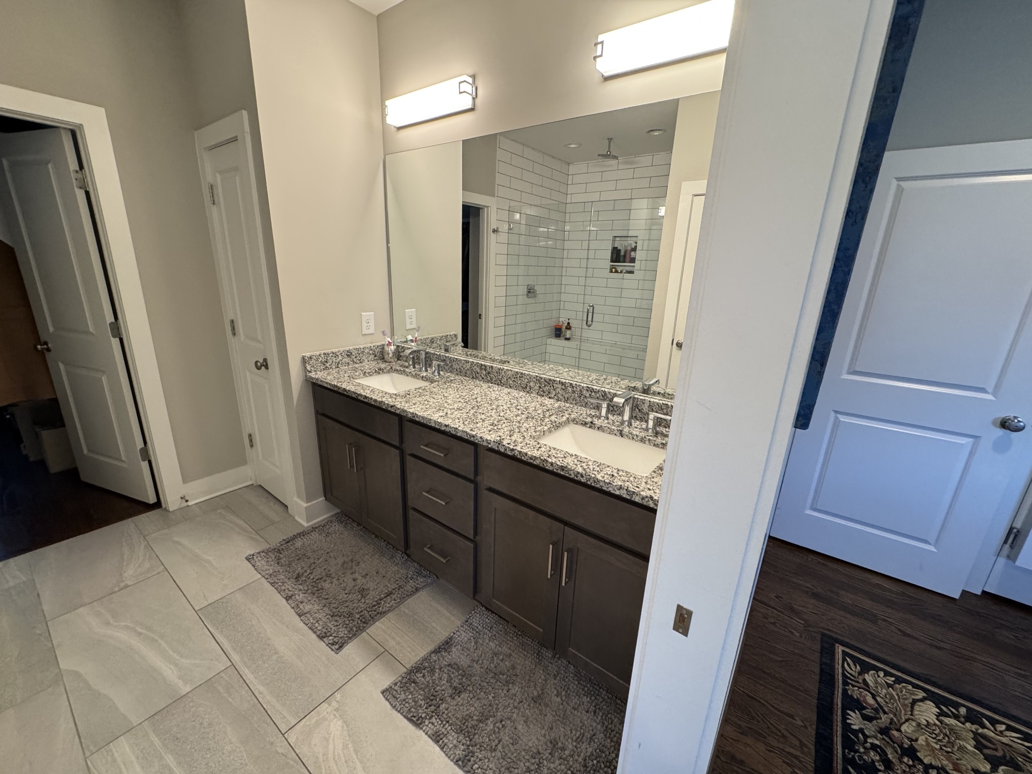40 Hubbard Street Nashville, TN 37210 - Photo 58 of 96 a bathroom with a granite countertop sink a mirror and a shower