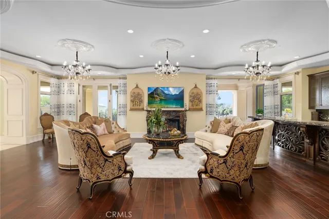 a living room with furniture chandelier and a chandelier
