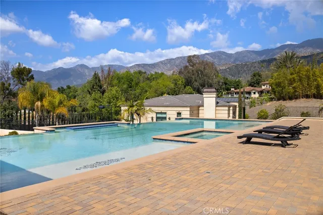 a living room with furniture chandelier and a fireplace