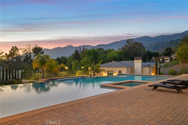 a spacious bedroom with a large bed and a chandelier