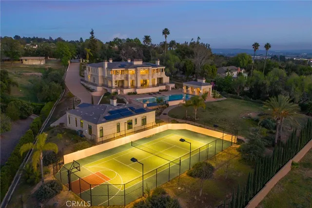 a view of a swimming pool with a patio and a garden