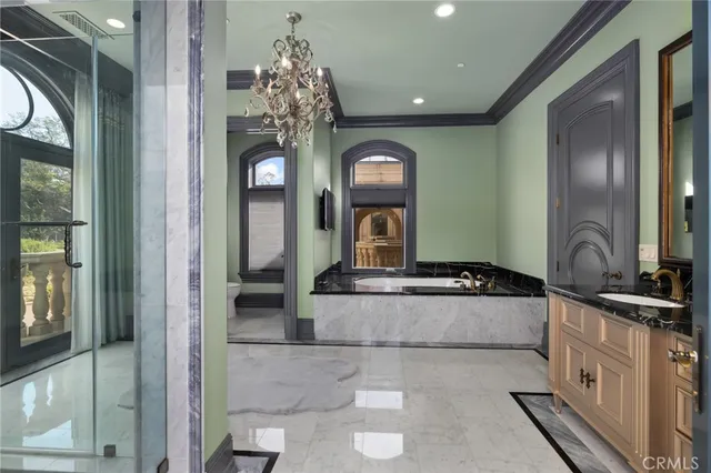 a living room with furniture a fireplace and a chandelier