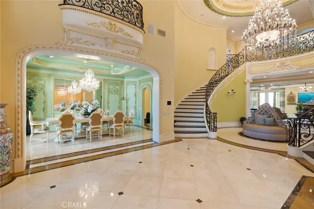 a lobby with furniture and a chandelier