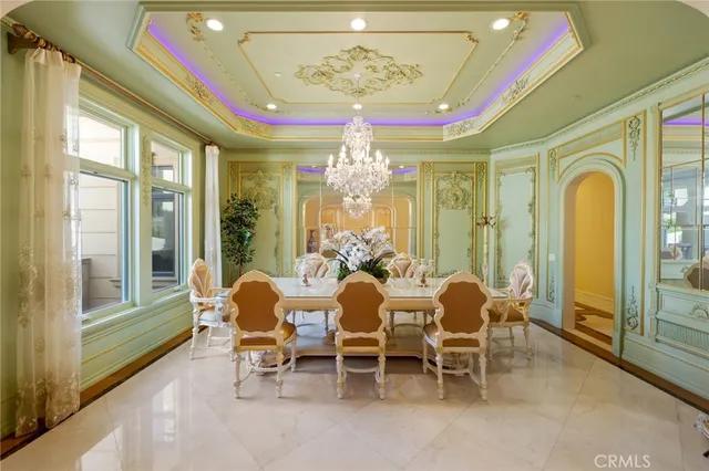 a dining room with furniture a chandelier and a rug