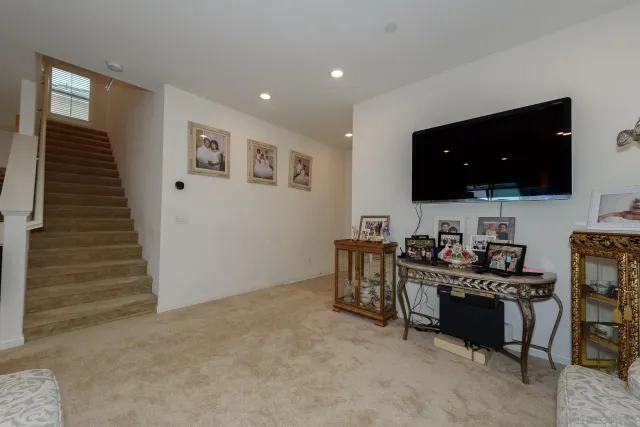 a view of a workspace with furniture and flat screen tv