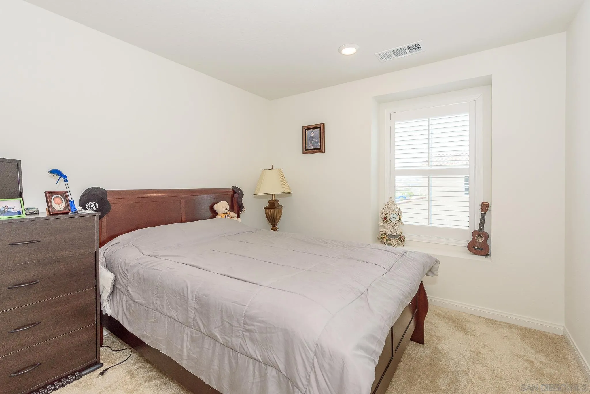 10761 Ensworth Way Spring Valley, CA 91978 - Photo 24 of 38 a bedroom with a bed and a window