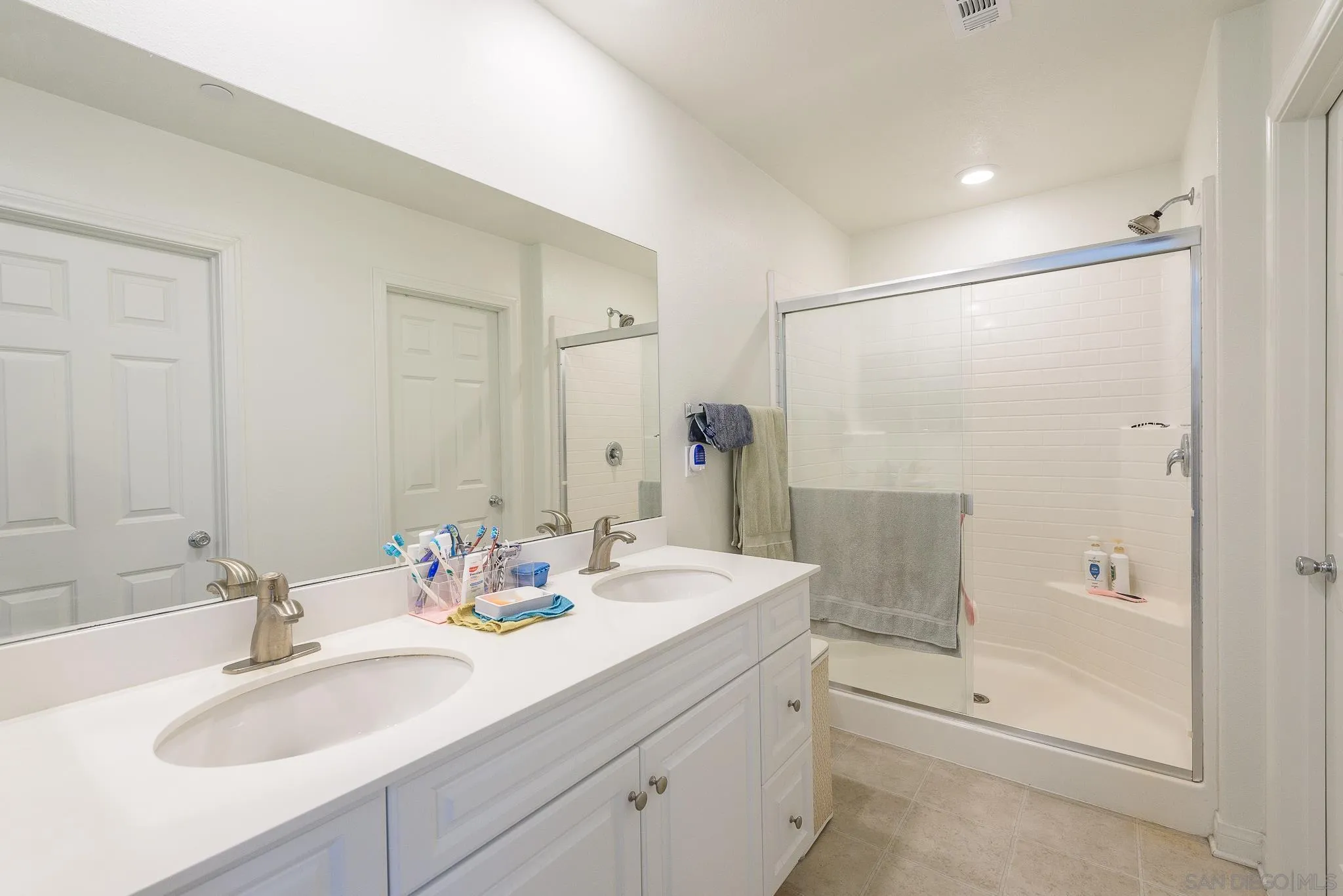 10761 Ensworth Way Spring Valley, CA 91978 - Photo 27 of 38 a bathroom with double sink and a mirror