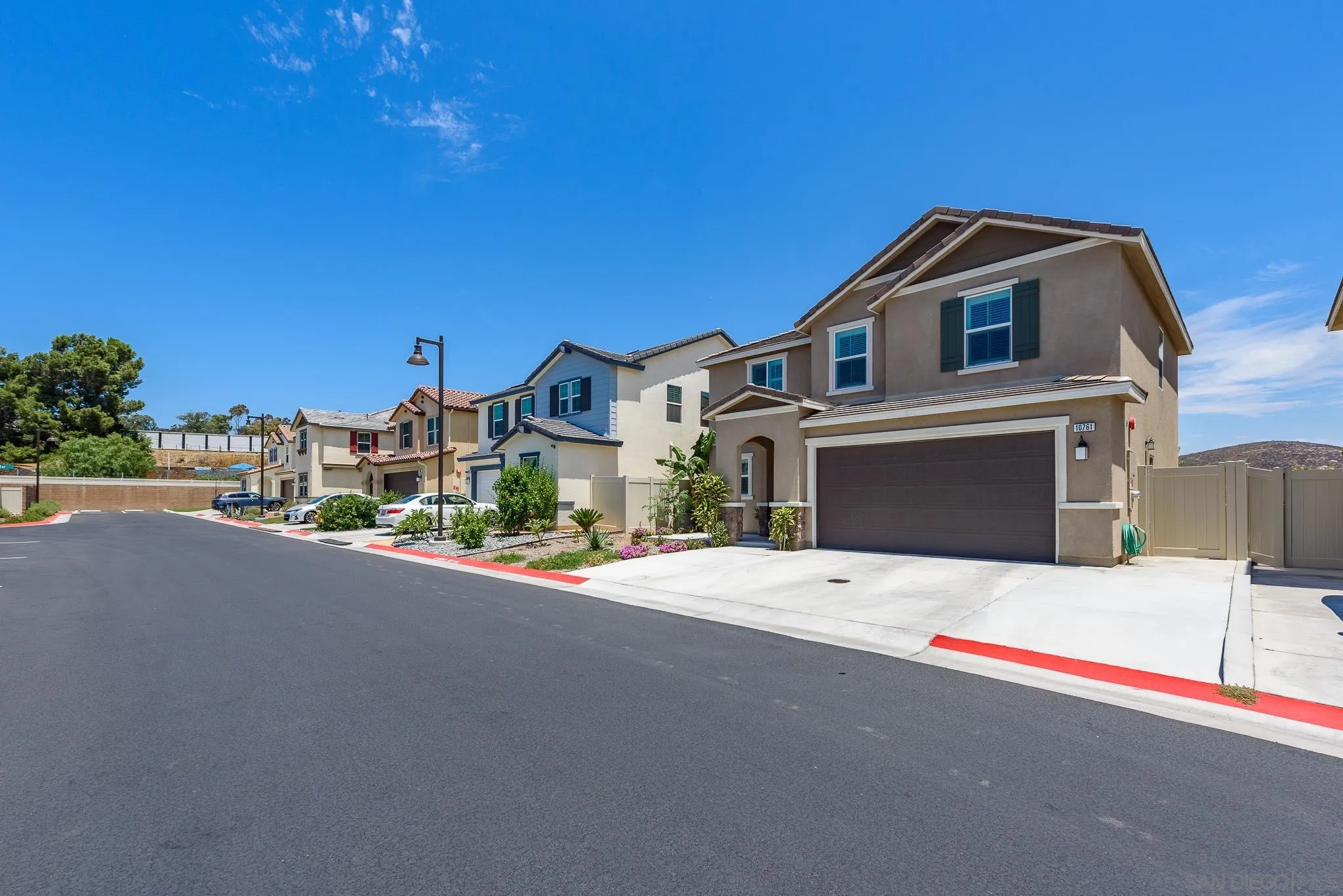 10761 Ensworth Way Spring Valley, CA 91978 - Photo 3 of 38 a front view of a house with a yard and garage