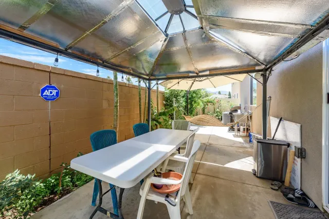 a backyard of a house with outdoor seating