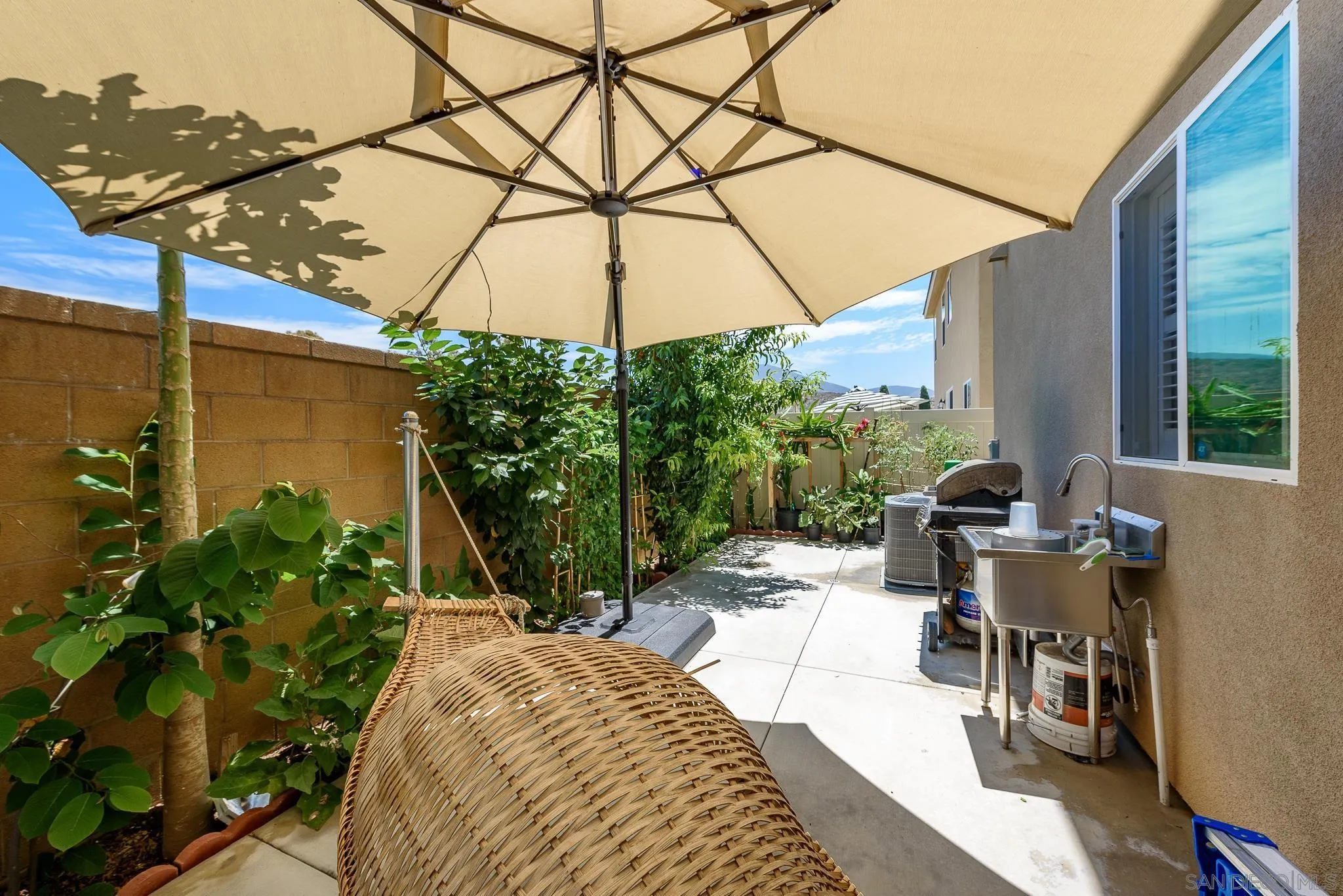 10761 Ensworth Way Spring Valley, CA 91978 - Photo 33 of 38 a view of a patio with table and chairs under an umbrella