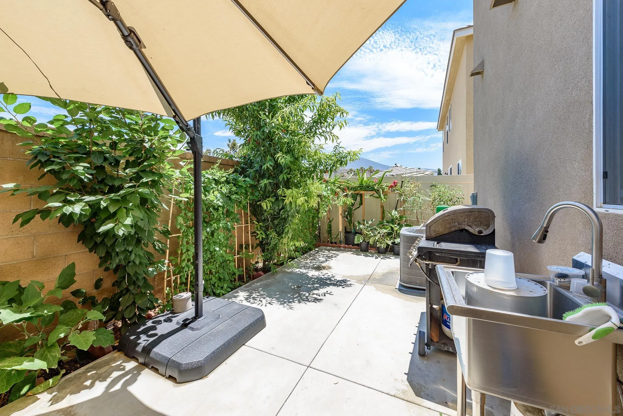 10761 Ensworth Way Spring Valley, CA 91978 - Photo 34 of 38 a backyard of a house with outdoor seating