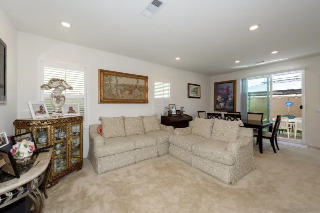a living room with furniture flowerpot and window