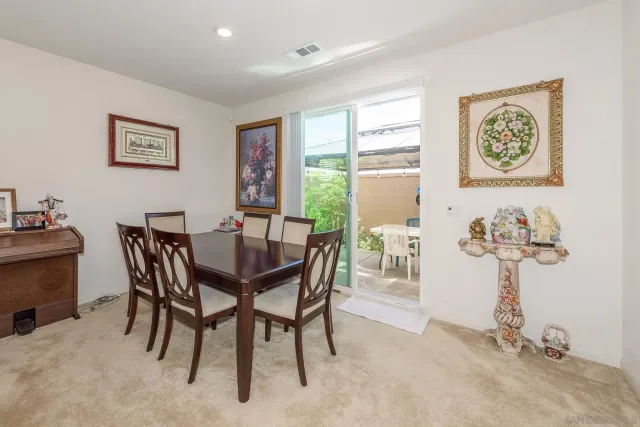 a dining room with furniture and window