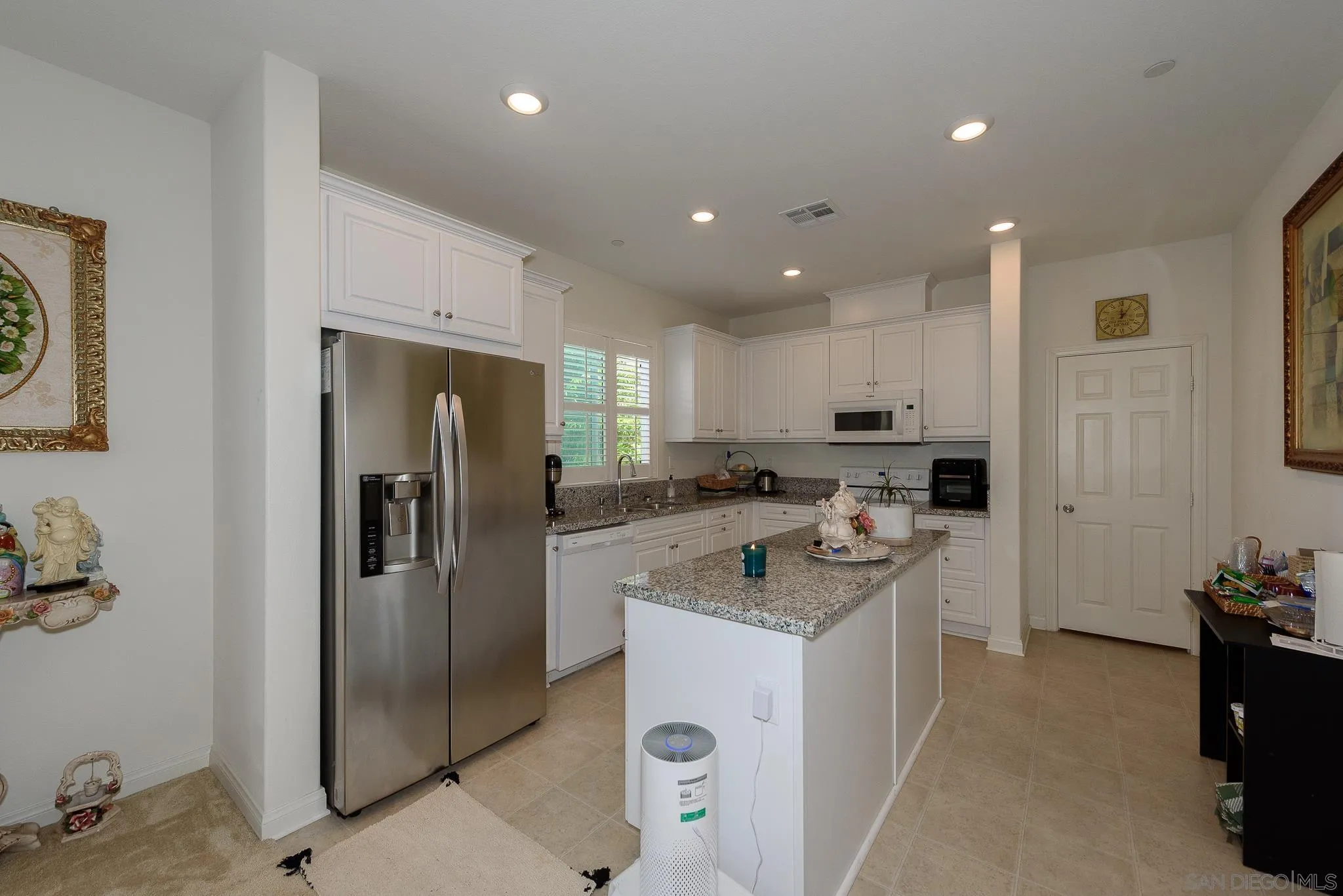 10761 Ensworth Way Spring Valley, CA 91978 - Photo 9 of 38 a kitchen with a sink and refrigerator