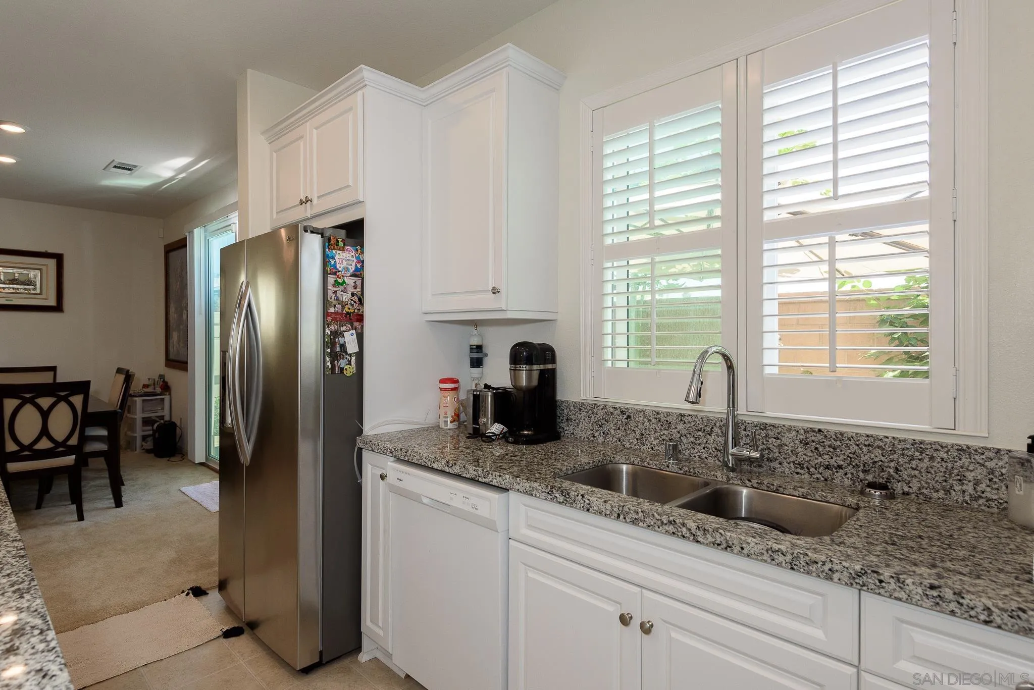 10761 Ensworth Way Spring Valley, CA 91978 - Photo 10 of 38 a kitchen with stainless steel appliances granite countertop a refrigerator a sink a stove and cabinets