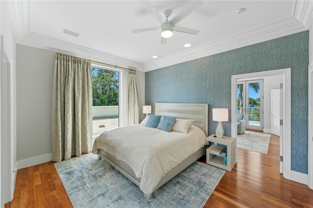 3315 Bay Shore Road Sarasota, FL 34234 - Photo 34 of 96 a bedroom with a large bed and a chandelier