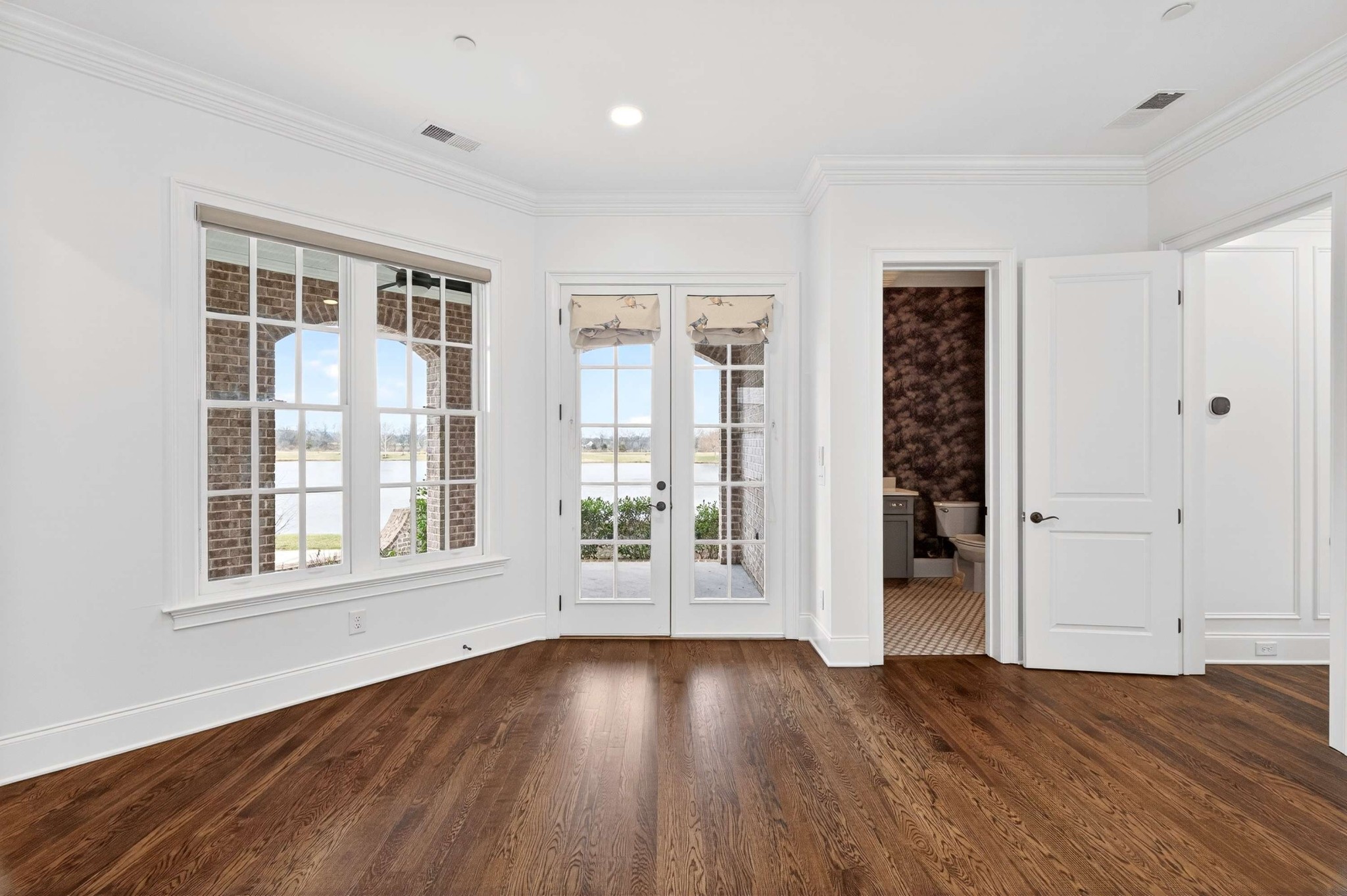 165 Front Street Franklin, TN 37064 - Photo 17 of 63 an empty room with wooden floor and windows