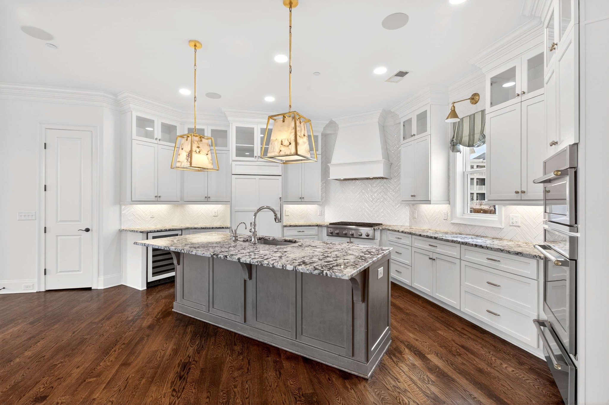 165 Front Street Franklin, TN 37064 - Photo 26 of 63 a kitchen with stainless steel appliances granite countertop a sink a stove and a wooden floors