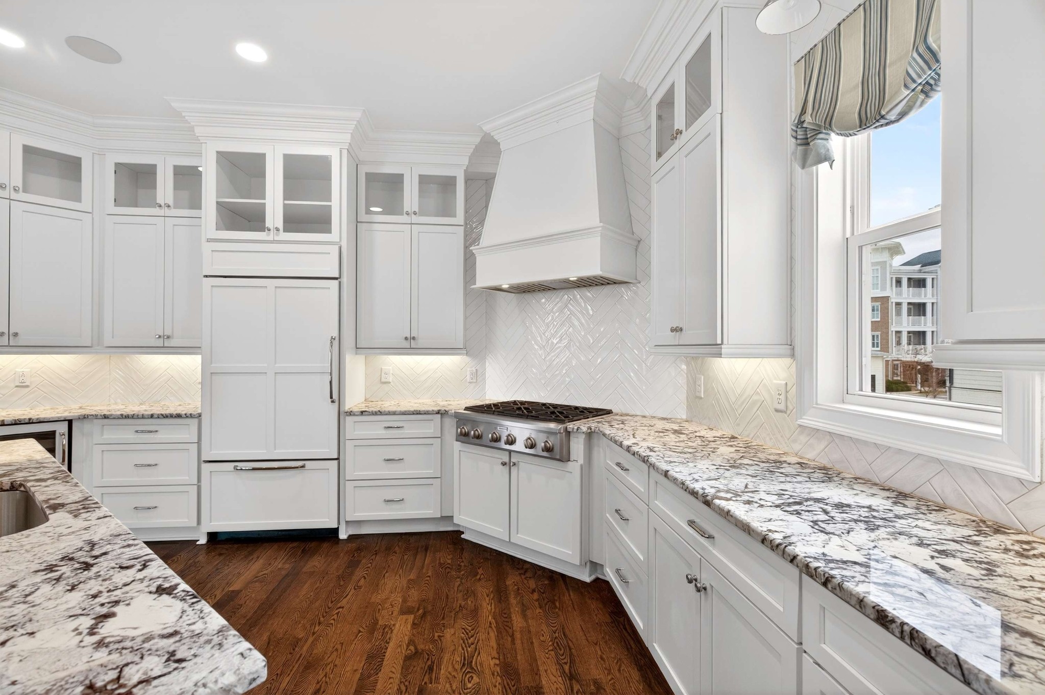 165 Front Street Franklin, TN 37064 - Photo 37 of 63 a kitchen with granite countertop white cabinets and white appliances