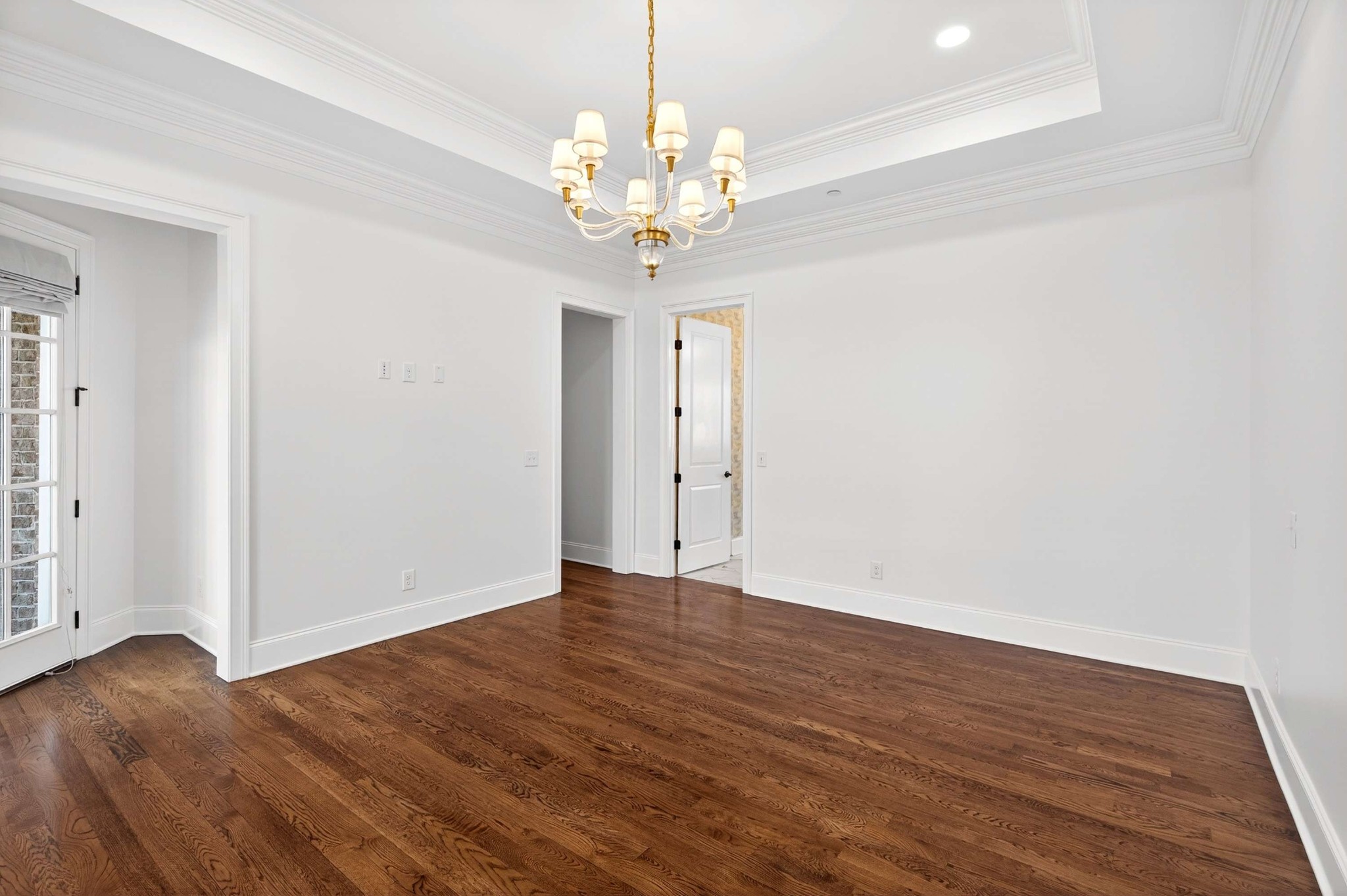 165 Front Street Franklin, TN 37064 - Photo 51 of 63 a view of an empty room with wooden floor and a chandelier