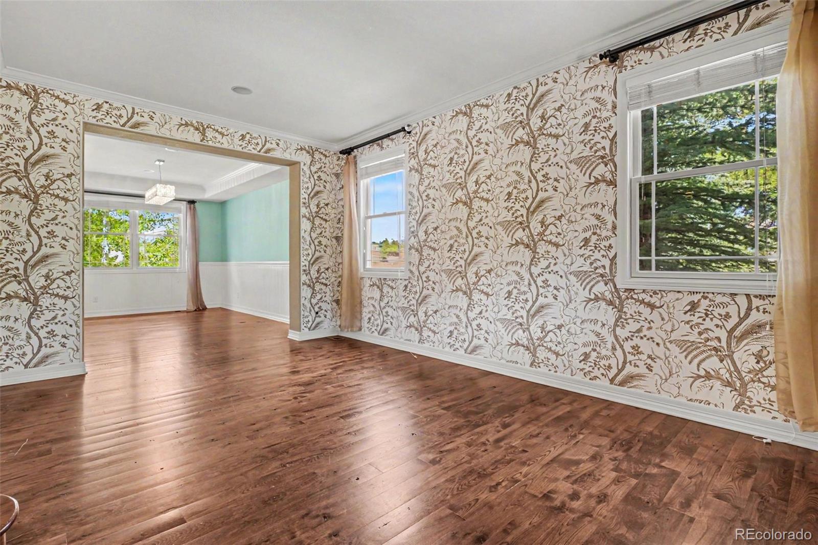 791 Elk Rest Road Evergreen, CO 80439 - Photo 5 of 46 an empty room with wooden floor and windows