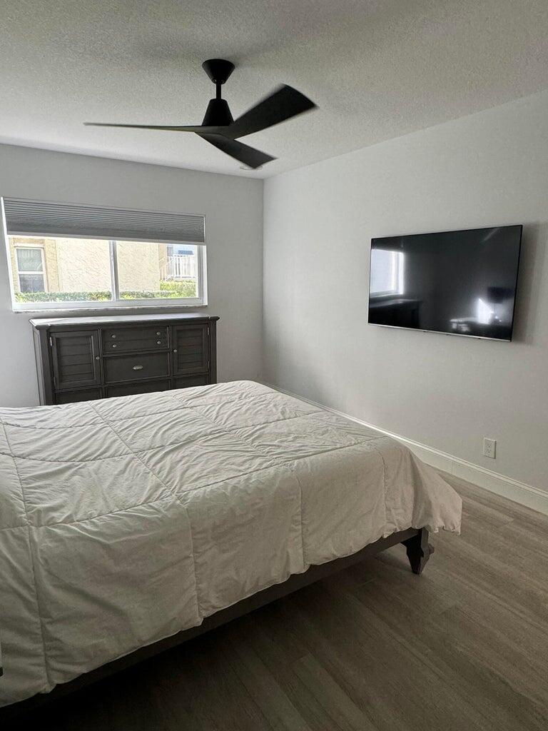 650 Snug Harbor Drive, Unit G110 Boynton Beach, FL 33435 - Photo 13 of 34 a bedroom with a bed and a flat screen tv