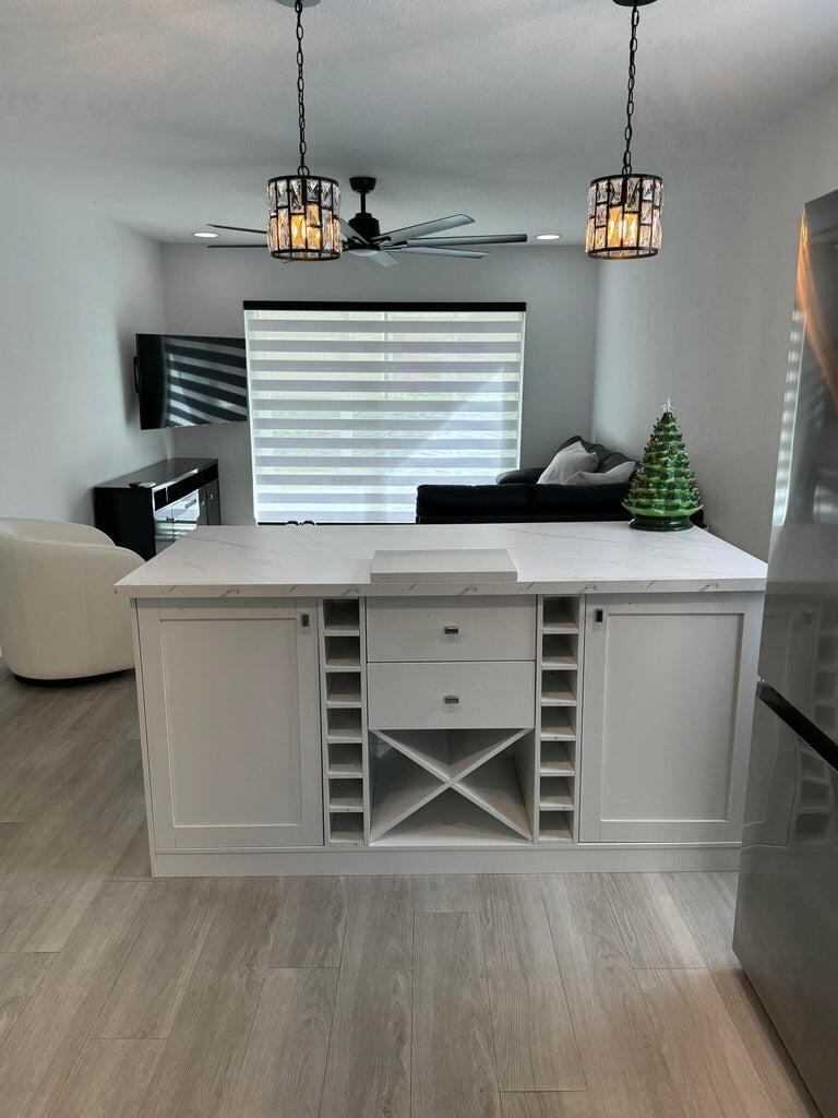 650 Snug Harbor Drive, Unit G110 Boynton Beach, FL 33435 - Photo 8 of 34 a kitchen with cabinets wooden floor and a window