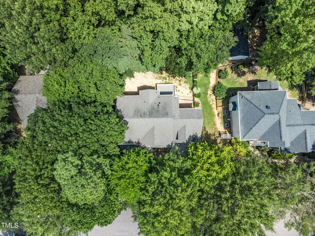 an aerial view of a house with swimming pool and garden