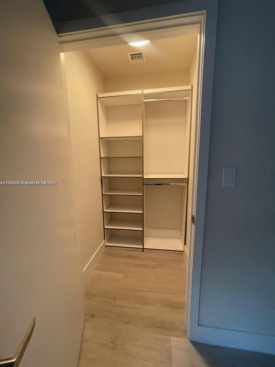 2505 Northeast 193rd Street, Unit 4204 Aventura, FL 33180 - Photo 11 of 18 a room with walk in closet and empty racks