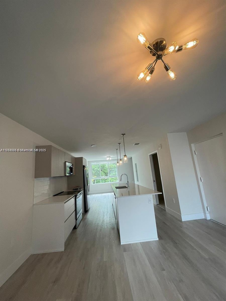 2505 Northeast 193rd Street, Unit 4204 Aventura, FL 33180 - Photo 15 of 18 a living room with furniture and a wooden floor