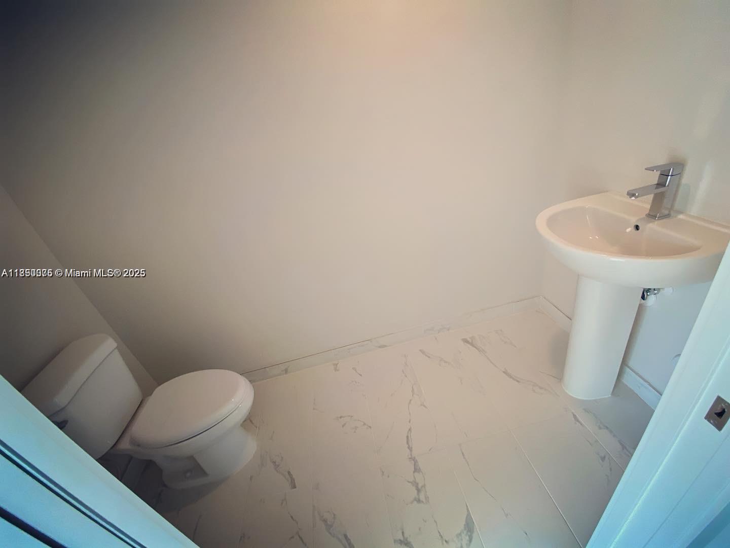 2505 Northeast 193rd Street, Unit 4204 Aventura, FL 33180 - Photo 4 of 18 a bathroom with a sink mirror and toilet