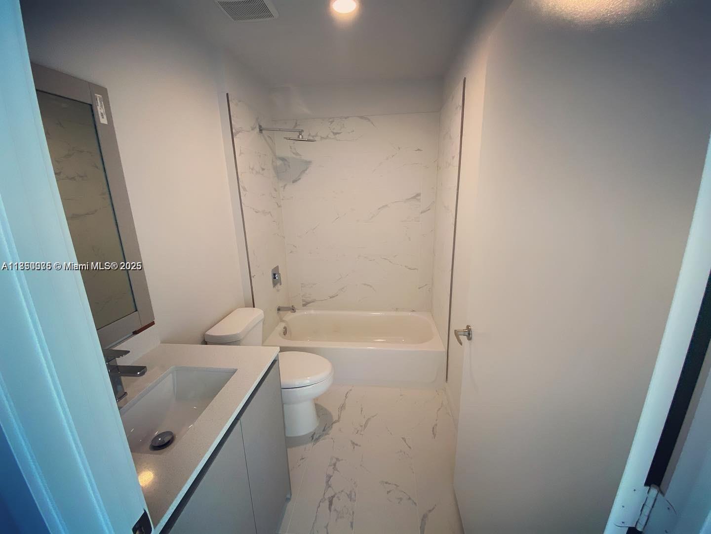 2505 Northeast 193rd Street, Unit 4204 Aventura, FL 33180 - Photo 6 of 18 a bathroom with a sink a toilet and shower