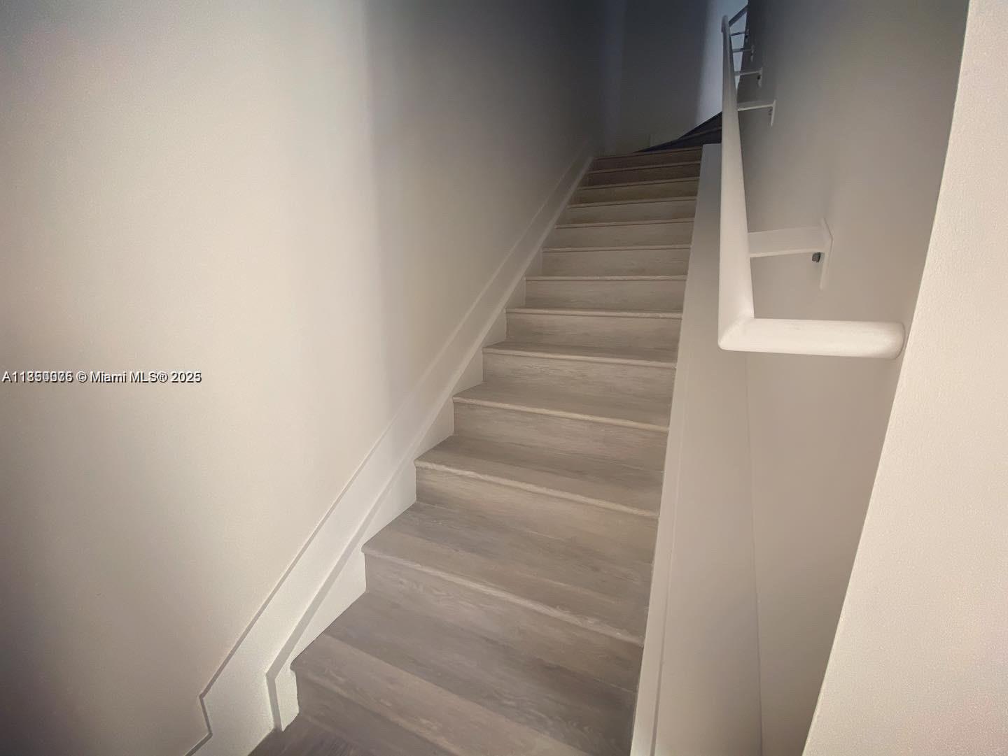 2505 Northeast 193rd Street, Unit 4204 Aventura, FL 33180 - Photo 8 of 18 a view of staircase with white walls
