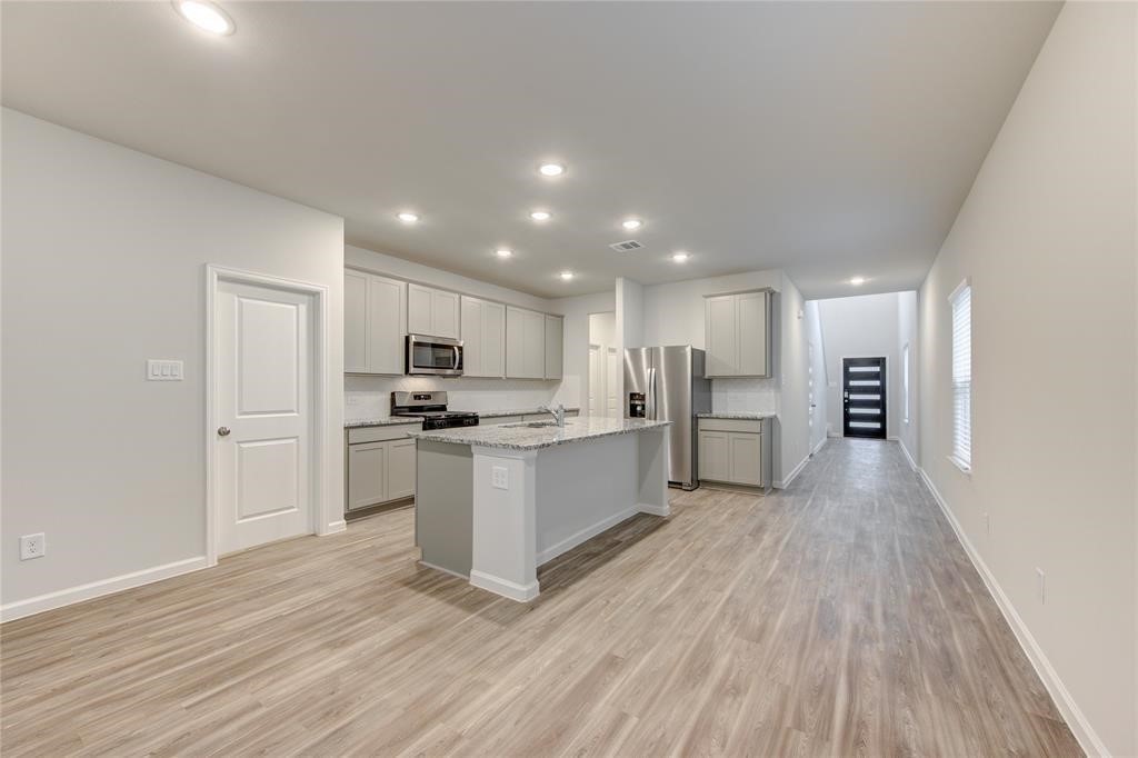 94 Valiant Ridge Trail Magnolia, TX 77354 - Photo 5 of 13 a view of kitchen with wooden floor