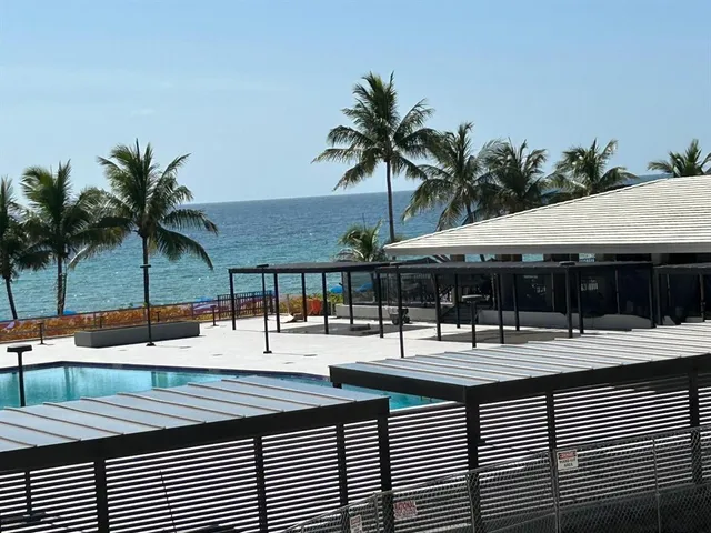 a backyard of a house with barbeque oven table and chairs