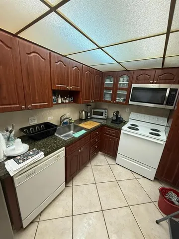 a kitchen with a stove a sink and a microwave