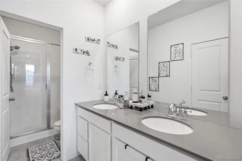 a bathroom with a double vanity sink mirror and double