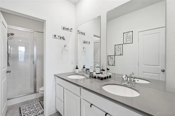 a bathroom with a double vanity sink mirror and double