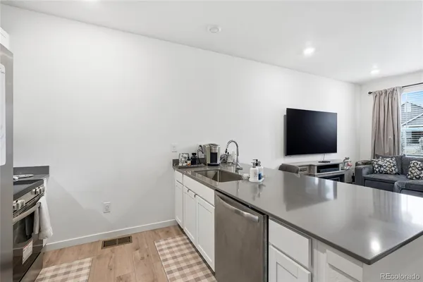 a kitchen with stainless steel appliances granite countertop a sink and a stove top oven