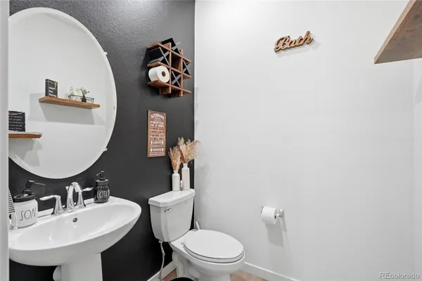 a bathroom with a sink toilet and mirror