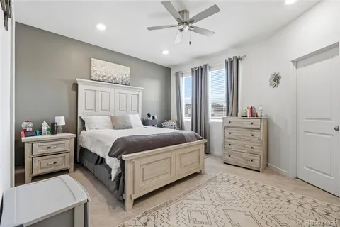 a spacious bedroom with a bed and a cabinets