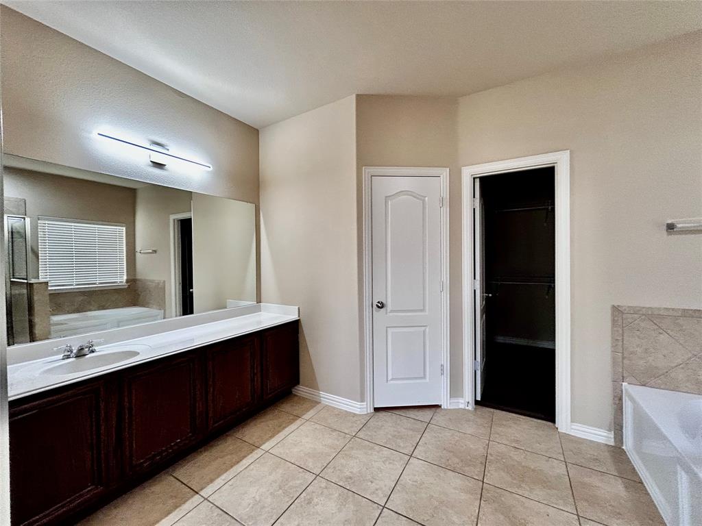 5112 Promised Land Drive McKinney, TX 75071 - Photo 11 of 30 a bathroom with a double vanity sink and a mirror