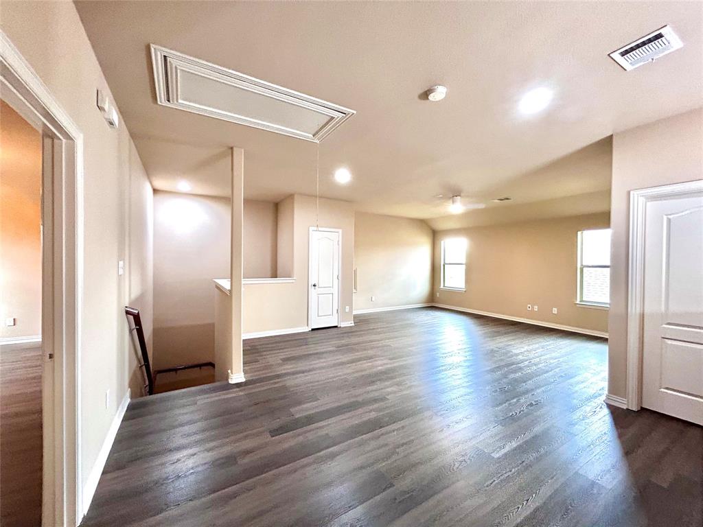 5112 Promised Land Drive McKinney, TX 75071 - Photo 15 of 30 a view of an empty room with wooden floor and a window