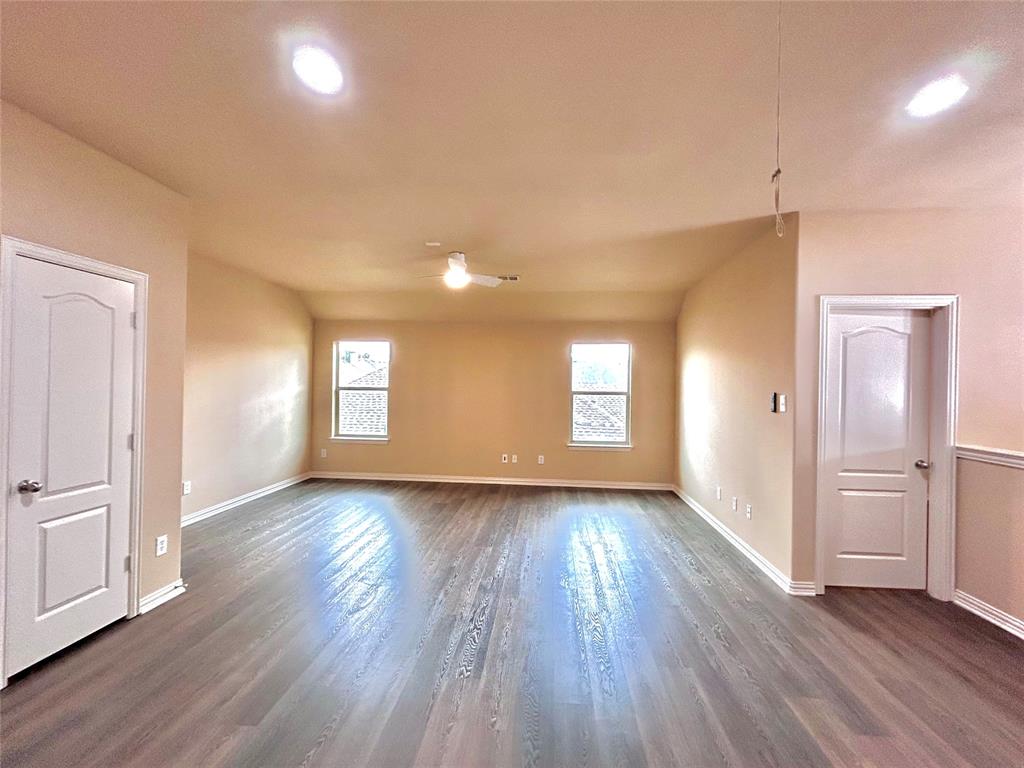 5112 Promised Land Drive McKinney, TX 75071 - Photo 16 of 30 a view of an empty room with window and wooden floor