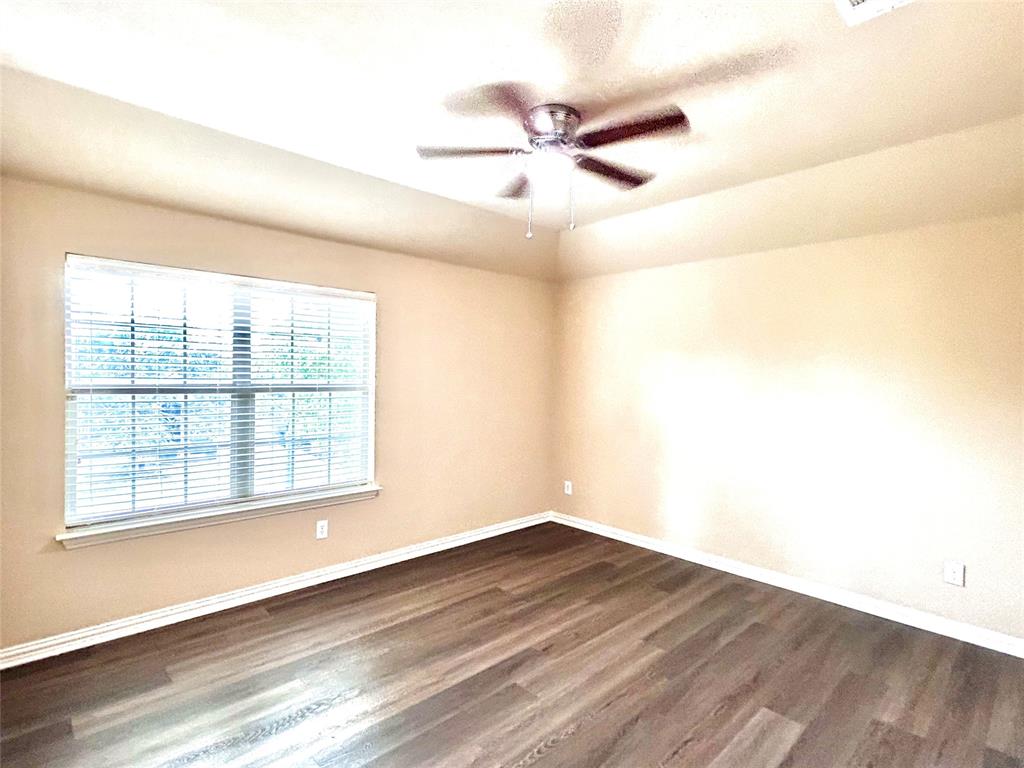 5112 Promised Land Drive McKinney, TX 75071 - Photo 17 of 30 a view of an empty room with wooden floor and a window