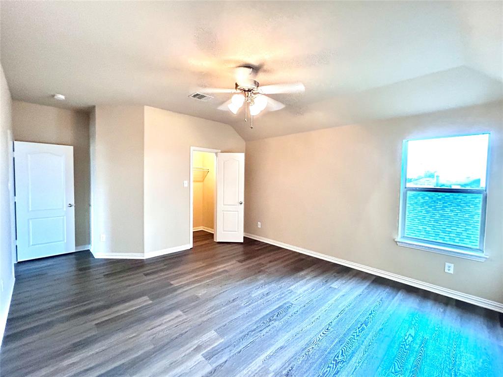 5112 Promised Land Drive McKinney, TX 75071 - Photo 19 of 30 a view of an empty room with window and wooden floor