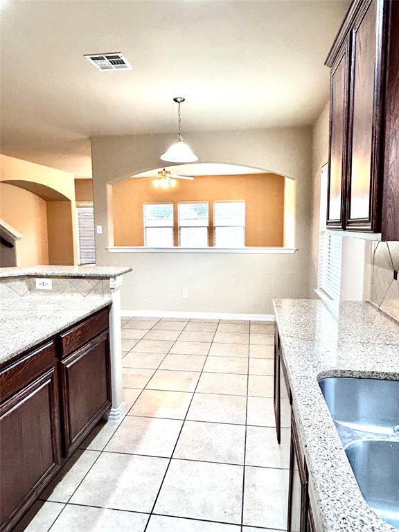 5112 Promised Land Drive McKinney, TX 75071 - Photo 24 of 30 a kitchen with stainless steel appliances granite countertop a sink and a stove