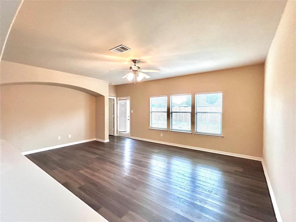 5112 Promised Land Drive McKinney, TX 75071 - Photo 6 of 30 an empty room with wooden floor and windows