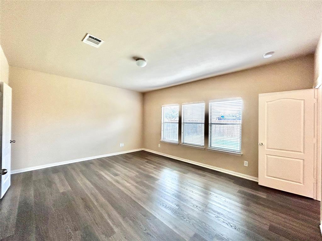 5112 Promised Land Drive McKinney, TX 75071 - Photo 9 of 30 an empty room with wooden floor and windows