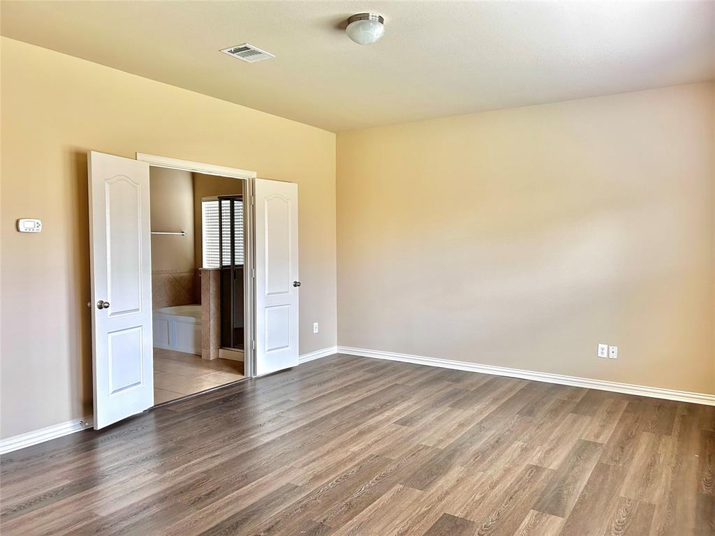 5112 Promised Land Drive McKinney, TX 75071 - Photo 10 of 30 wooden floor in an empty room with a window
